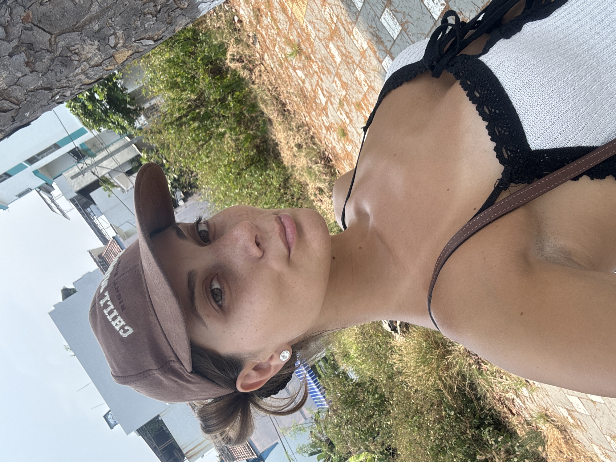 Woman takes morning selfies near parked car in Đà Nẵng