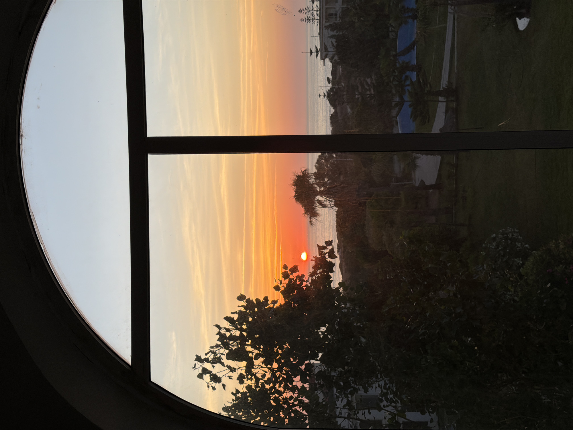 Sunset captured through arched window in Tangier, Morocco