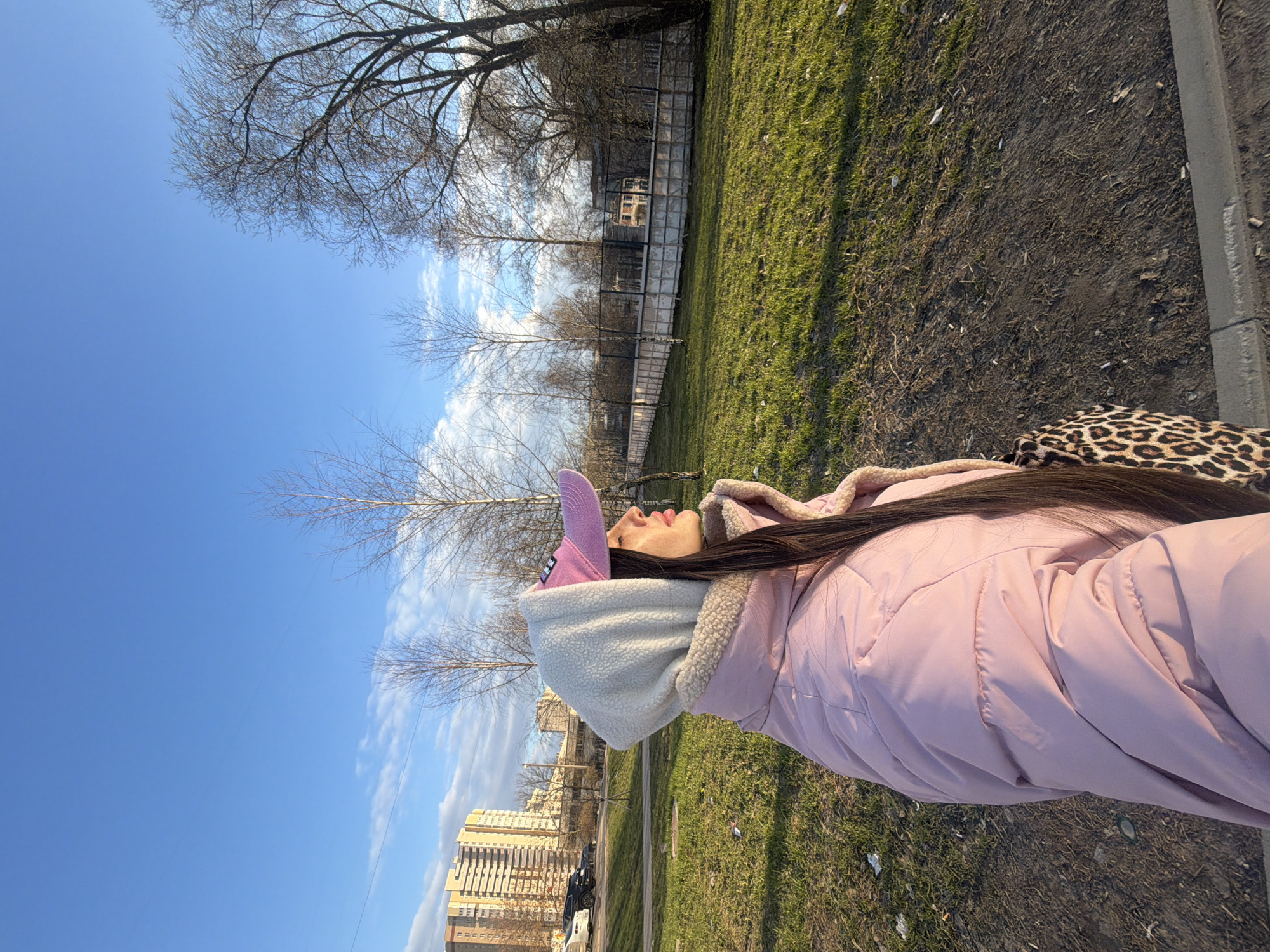 Woman in pink cap documented across Saint Petersburg locations