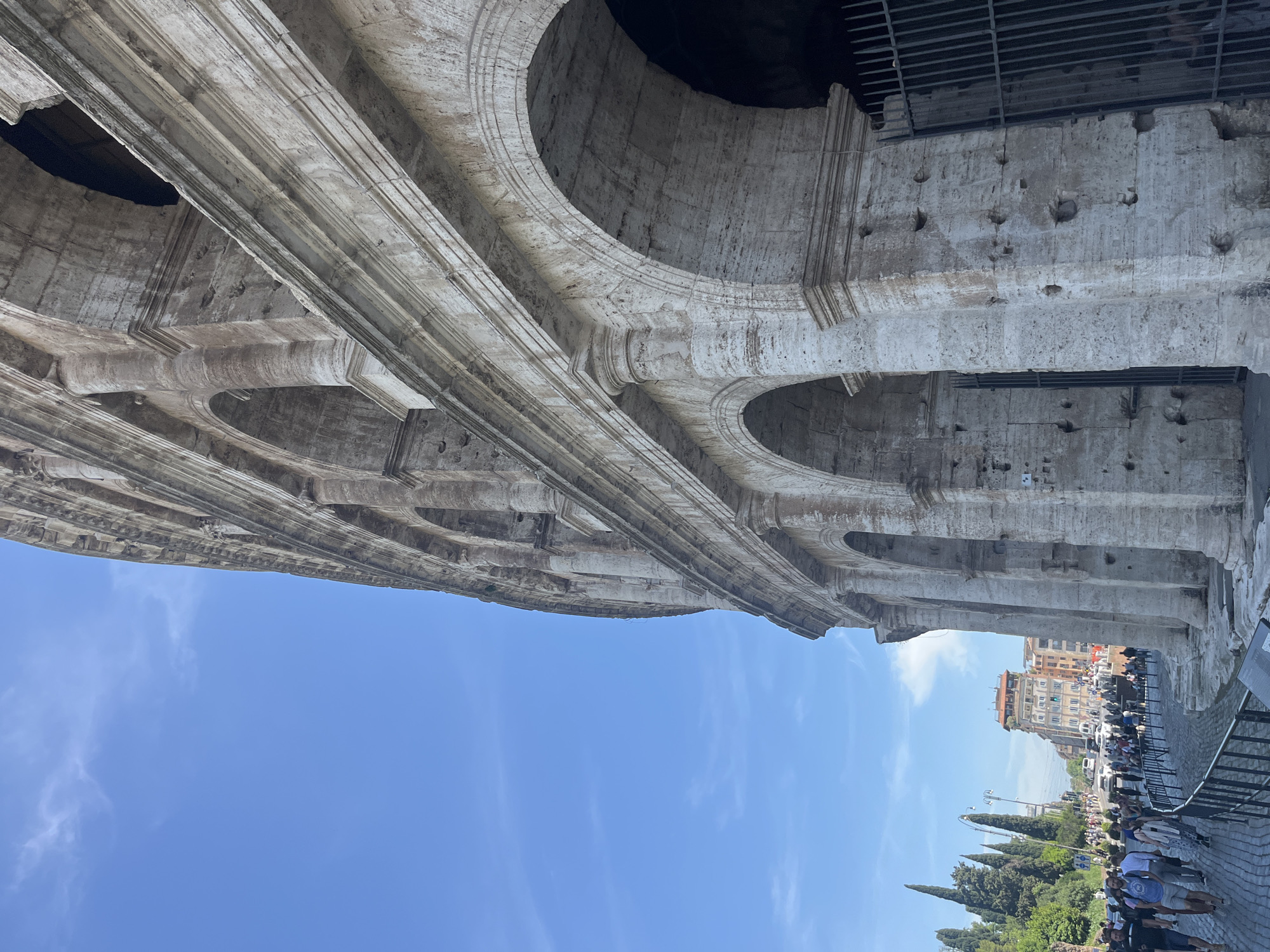 Tourist captures upward view of Colosseum's ancient stonework