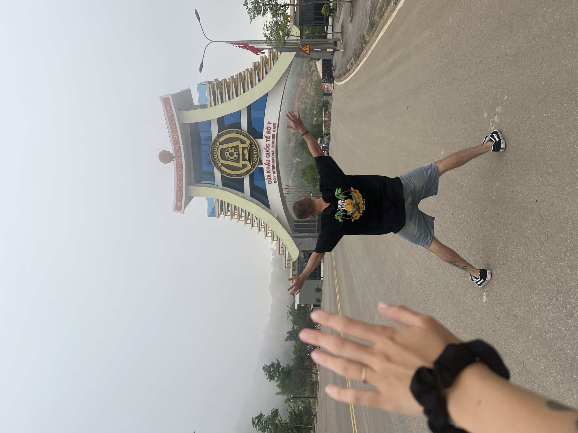Tourist poses playfully at Vietnam's Bờ Y International Border Gate