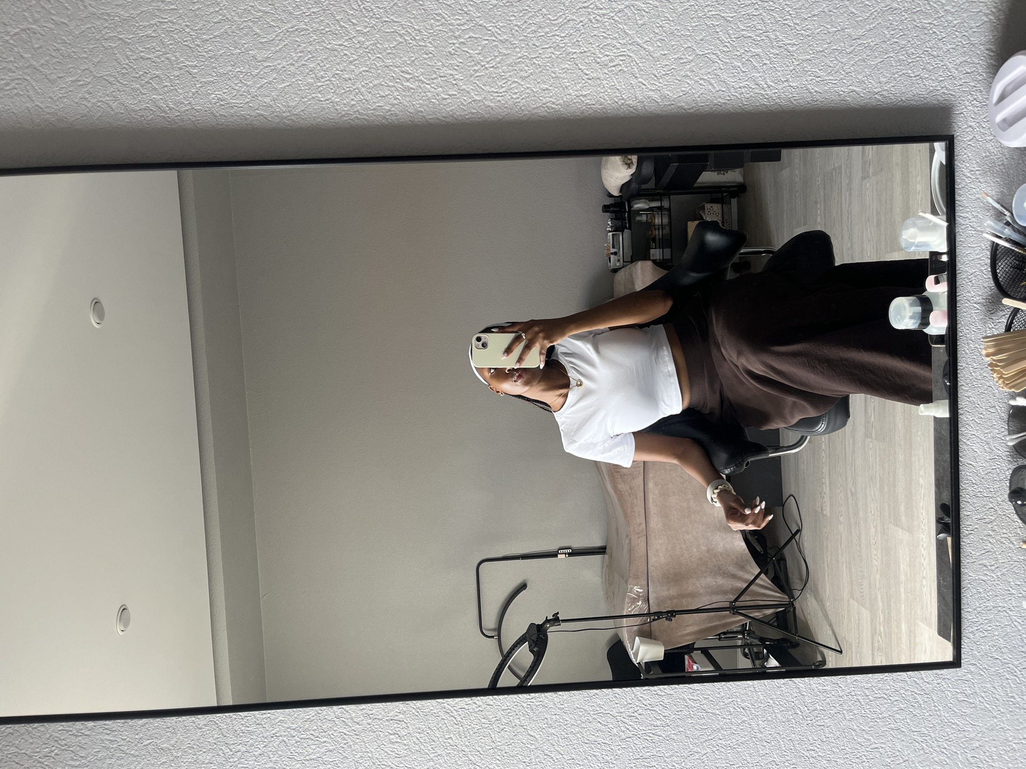 Woman takes mirror selfie in Kazan studio setting