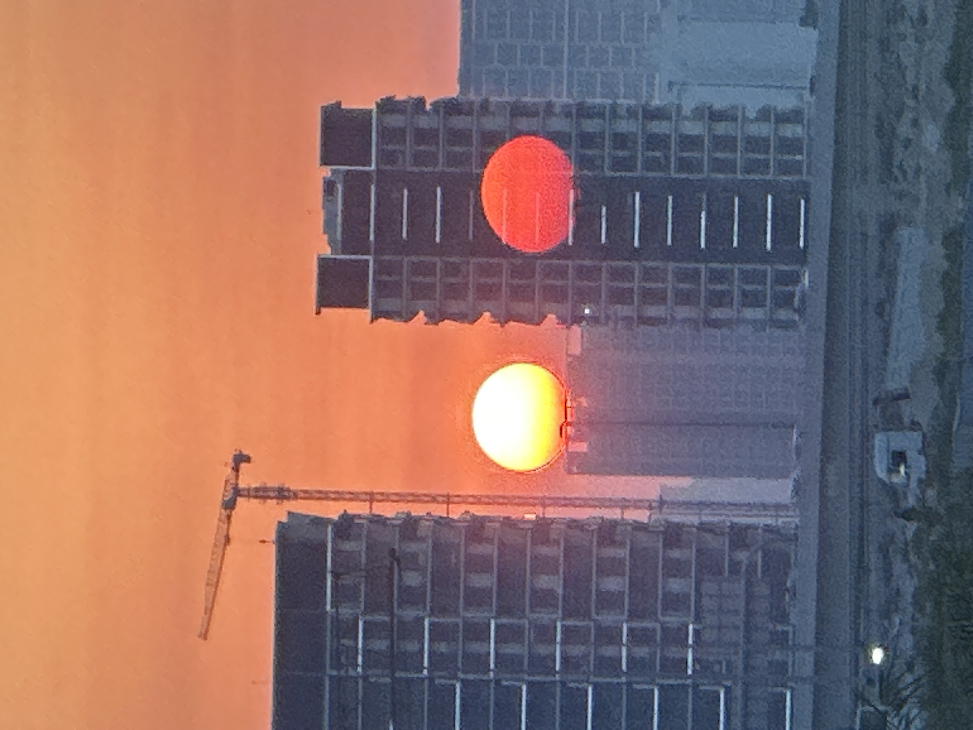 Dubai sunset over construction skyline, with a gym stop