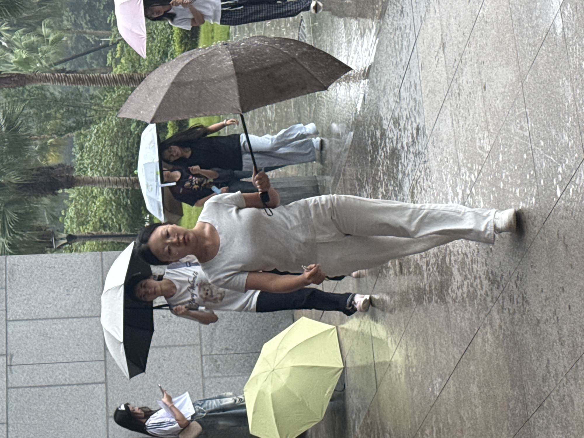 Rainy campus day in Jiangjin with outdoor crowds and indoor presentations.
