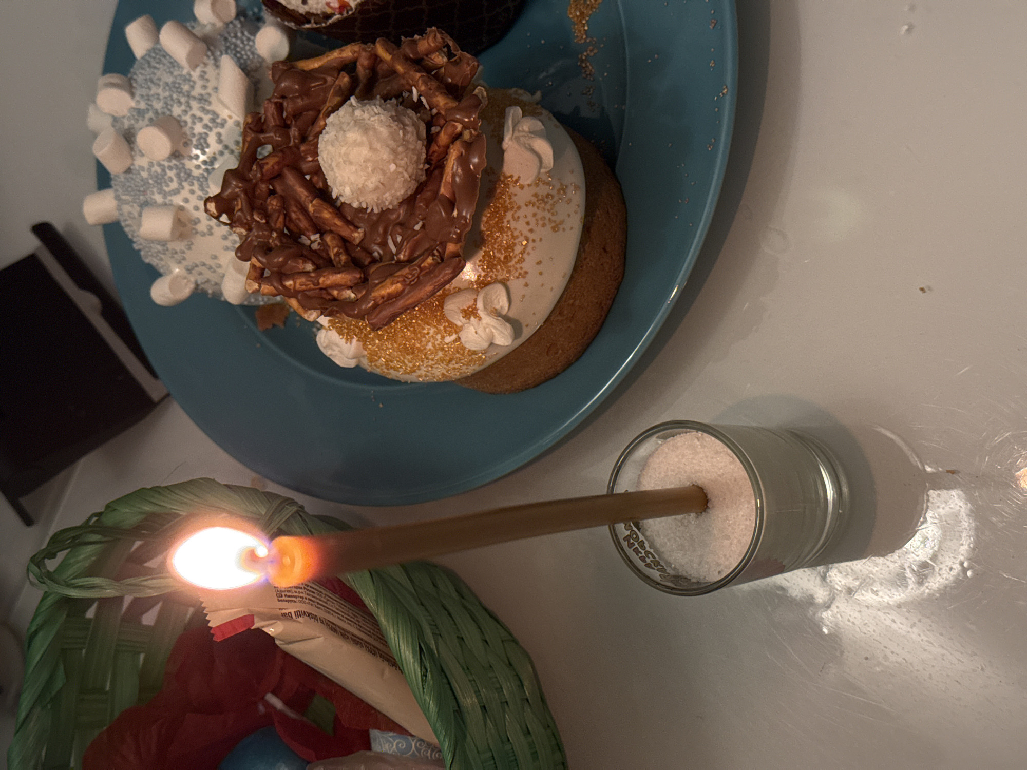 Evening candlelit gathering with cupcakes and treats documented