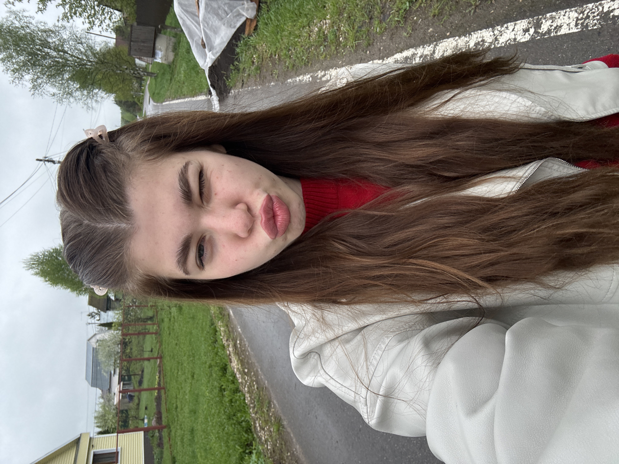 Woman takes selfies on wet road in Mещёры