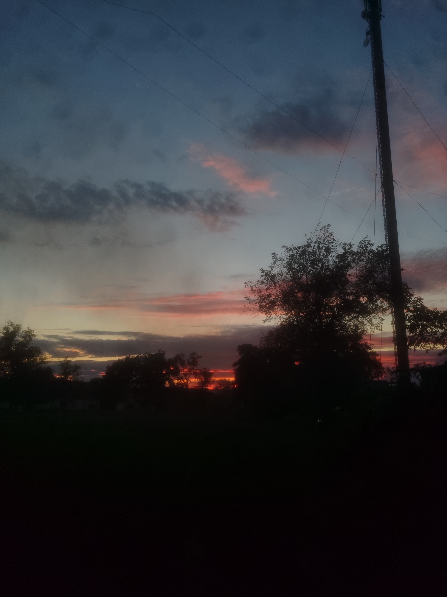 Outdoor evening hangout, drinks in hand, sunset backdrop