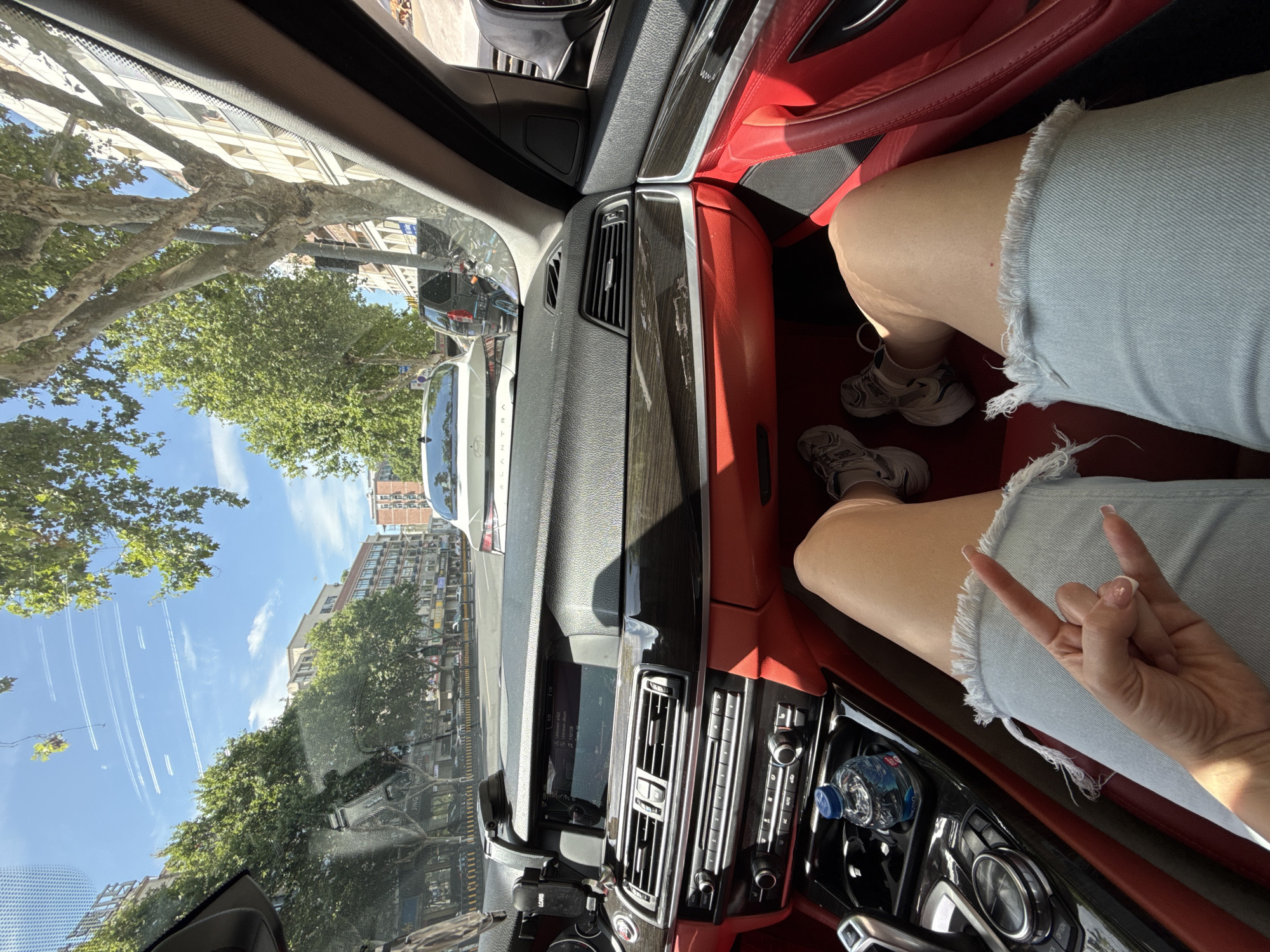 Person Makes Hand Gesture Inside Car in Yiwu