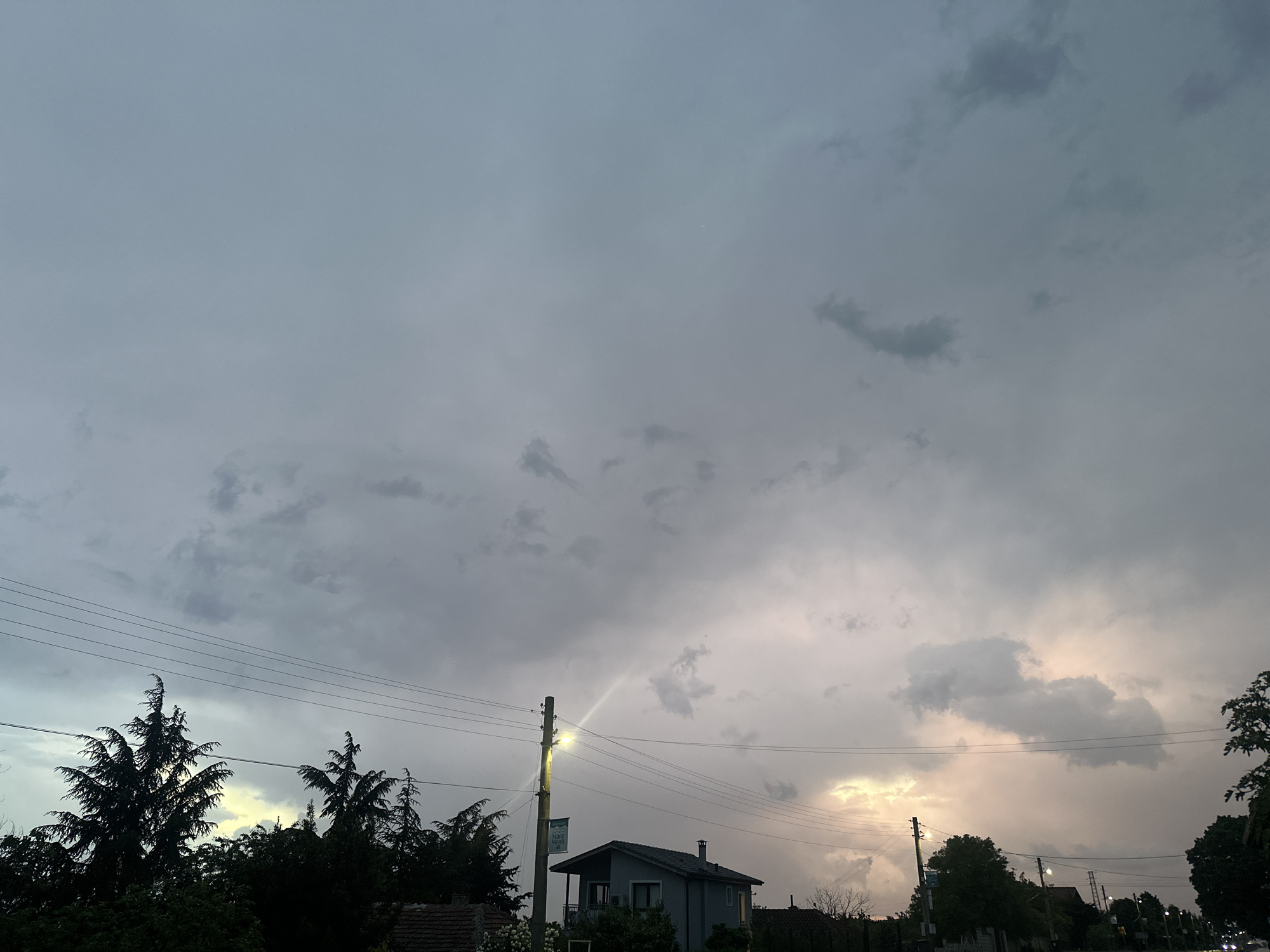 Evening storm clouds gather over wet streets in Byala