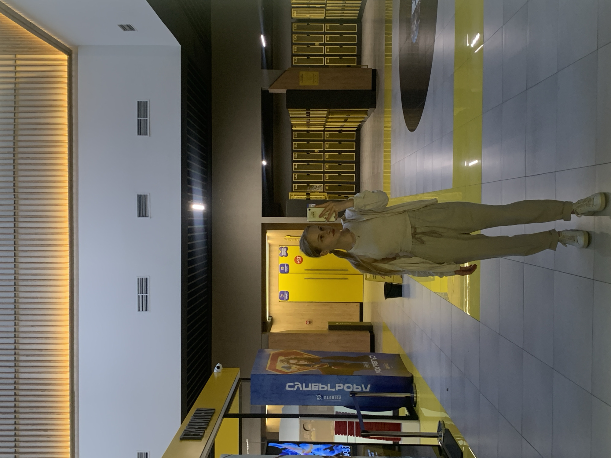 Woman takes selfies in modern Kyiv public facility