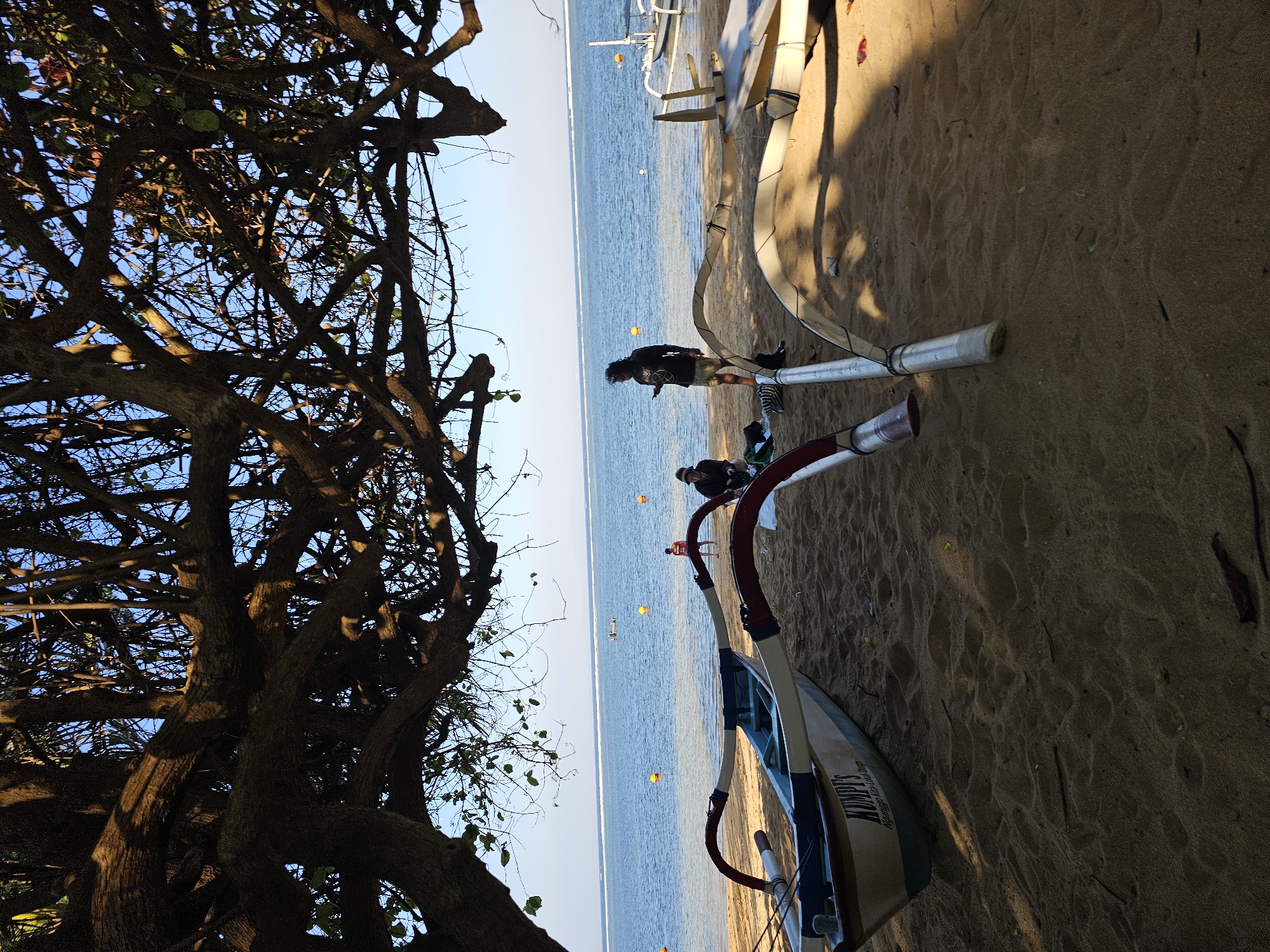 Sanur Beach morning: promenade walks, beachside barbecue, open-air dining setup
