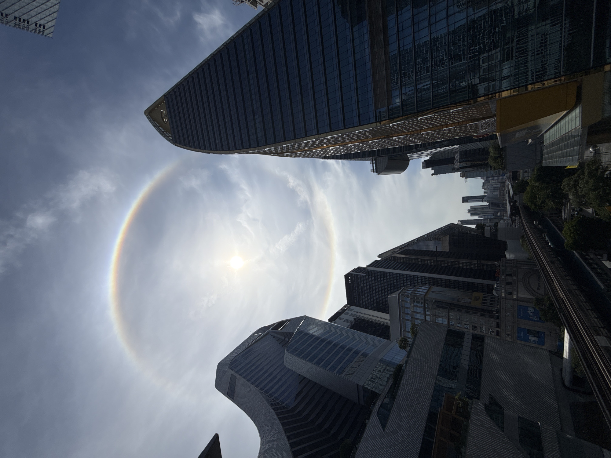 Sun halo rings over Bangkok's downtown skyline