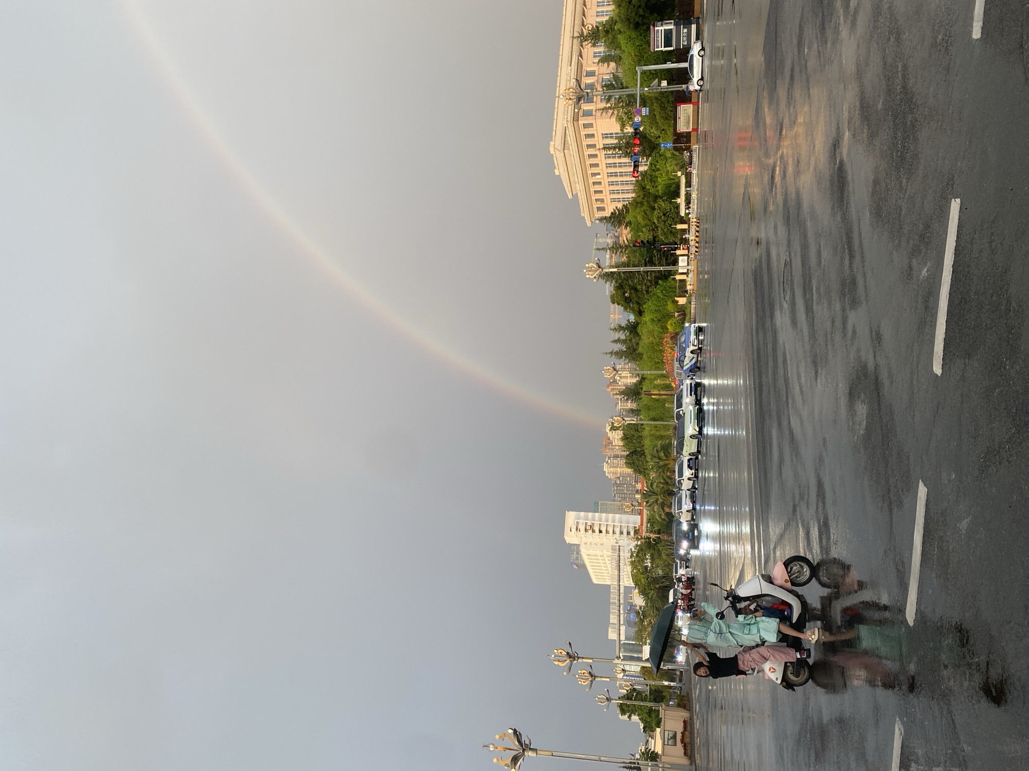 Rainbow over wet streets in Xishan District after summer rain