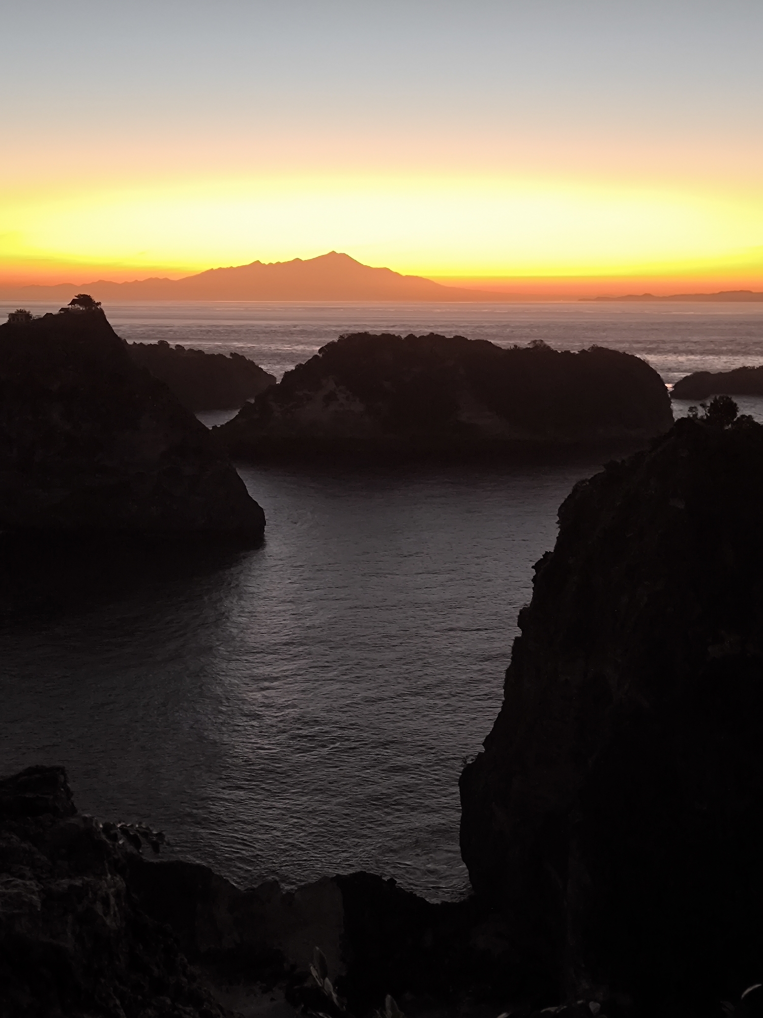 Sunset viewed from cliffs overlooking ocean in Nusa Penida