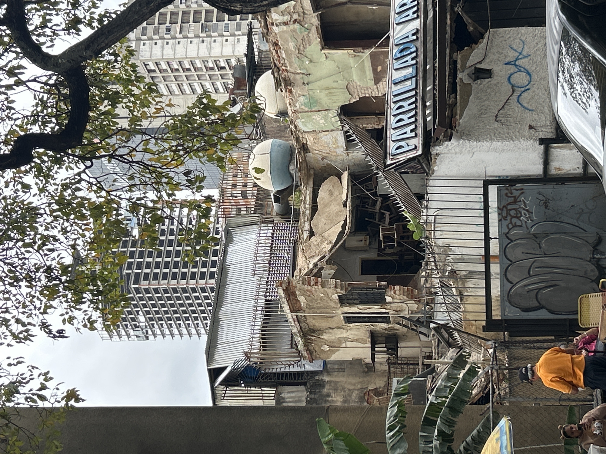 Crumbling apartment facades amid Caracas high-rises
