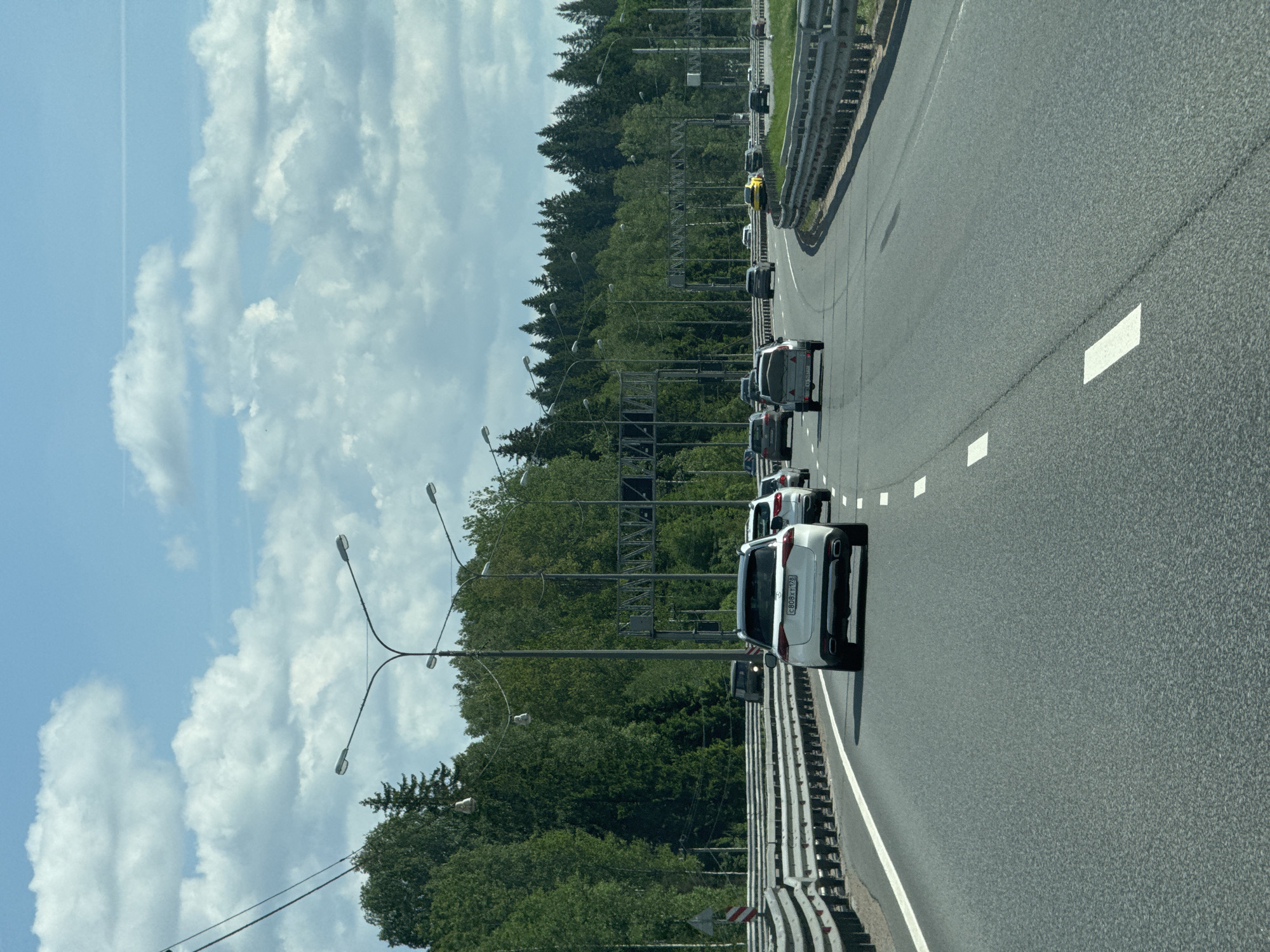 Highway traffic observed near Vartemyagi, Russia under clear skies