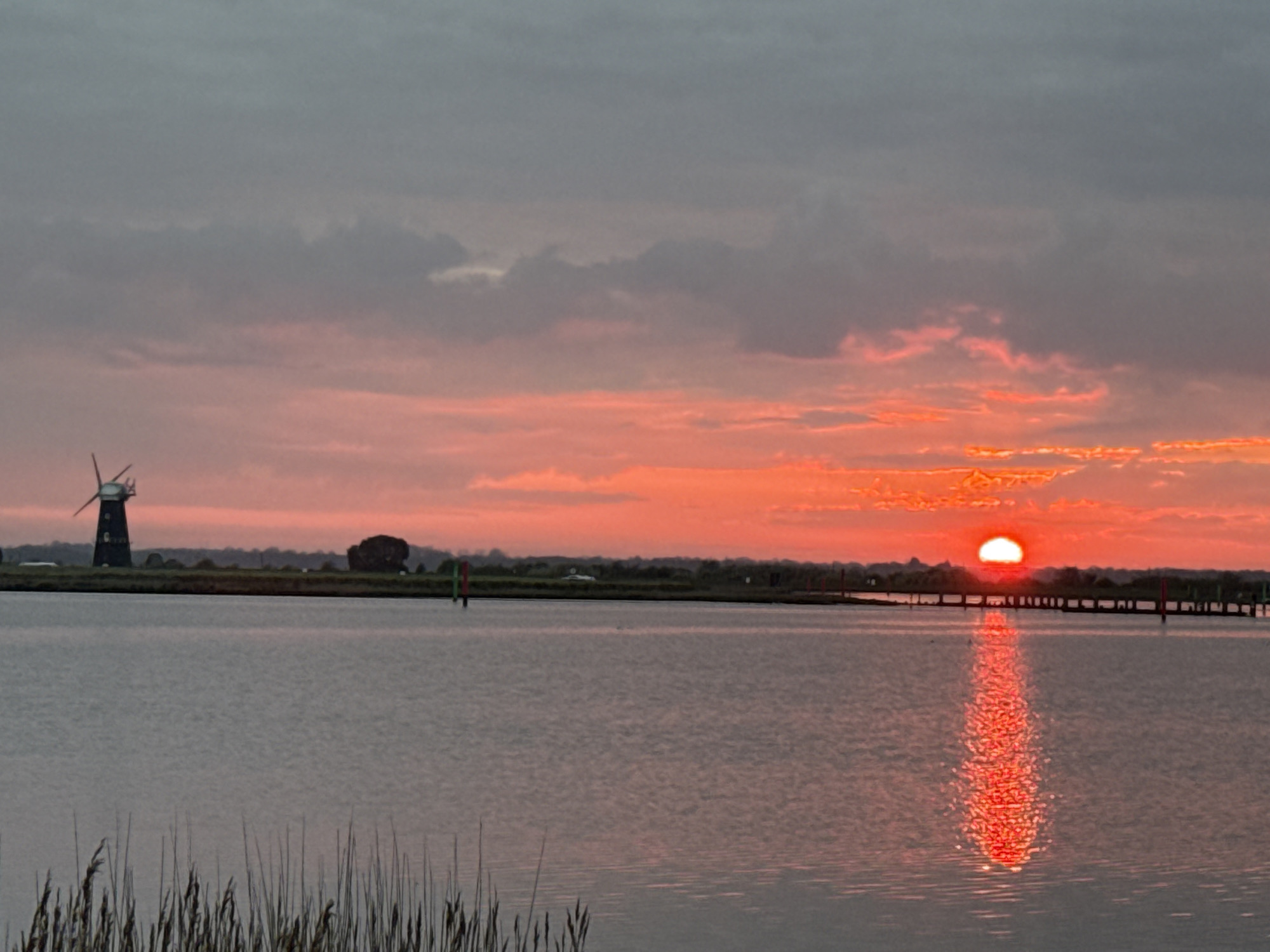 Sunset wetlands with windmill captured near Great Yarmouth