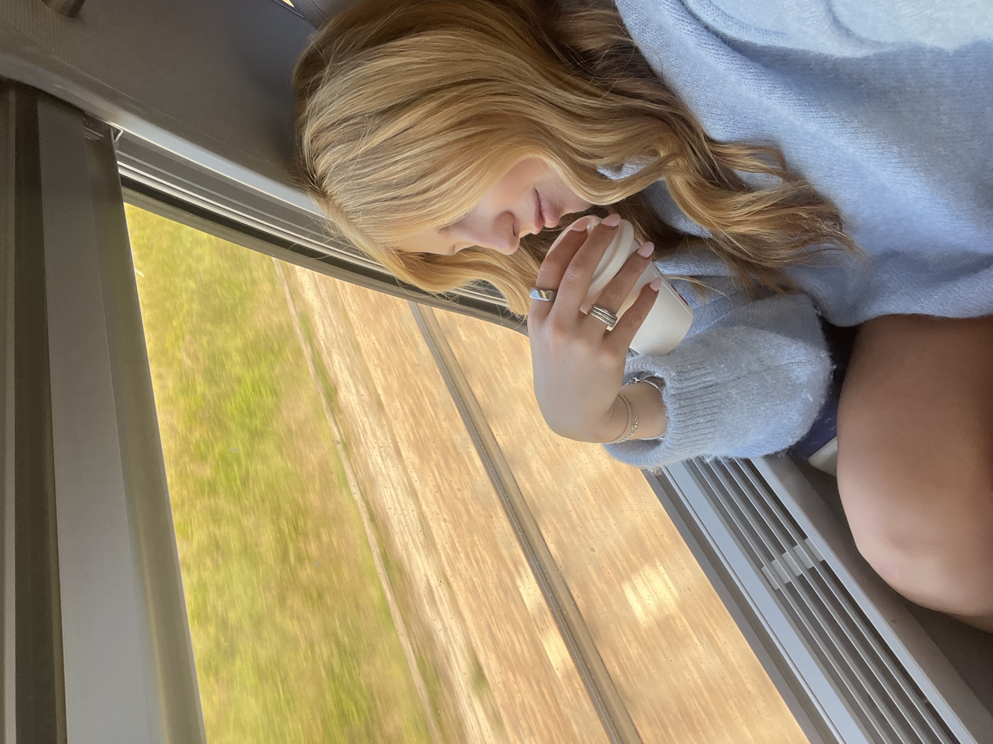Woman rests with coffee during morning commute in Marmeaux