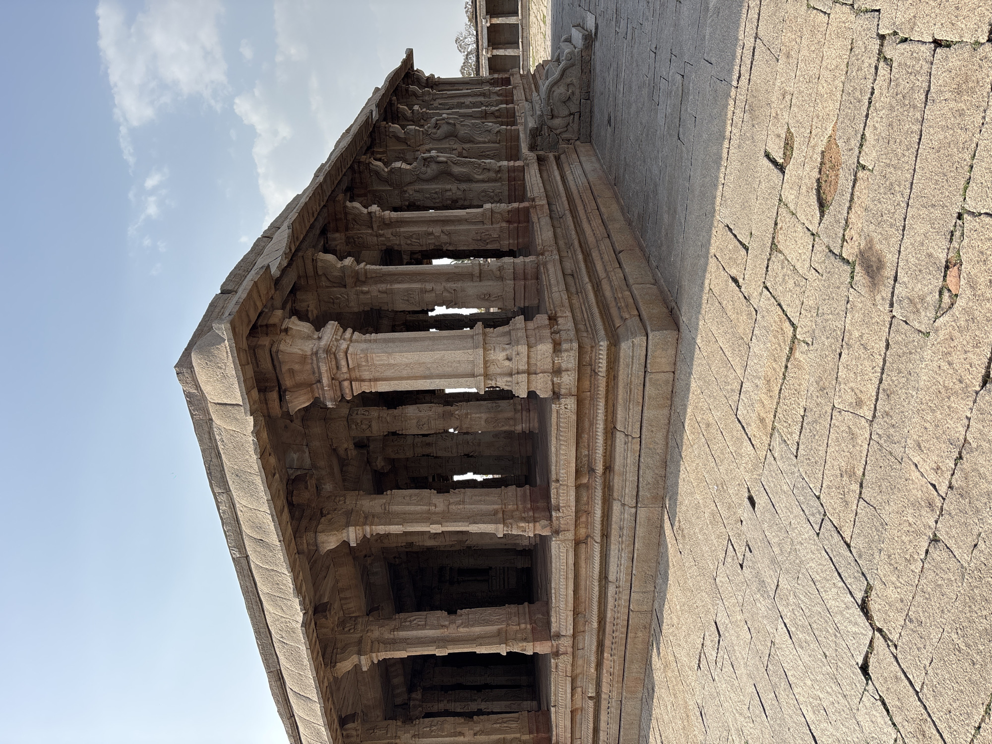 Tourist documents ancient temple carvings in Kamalapura, India