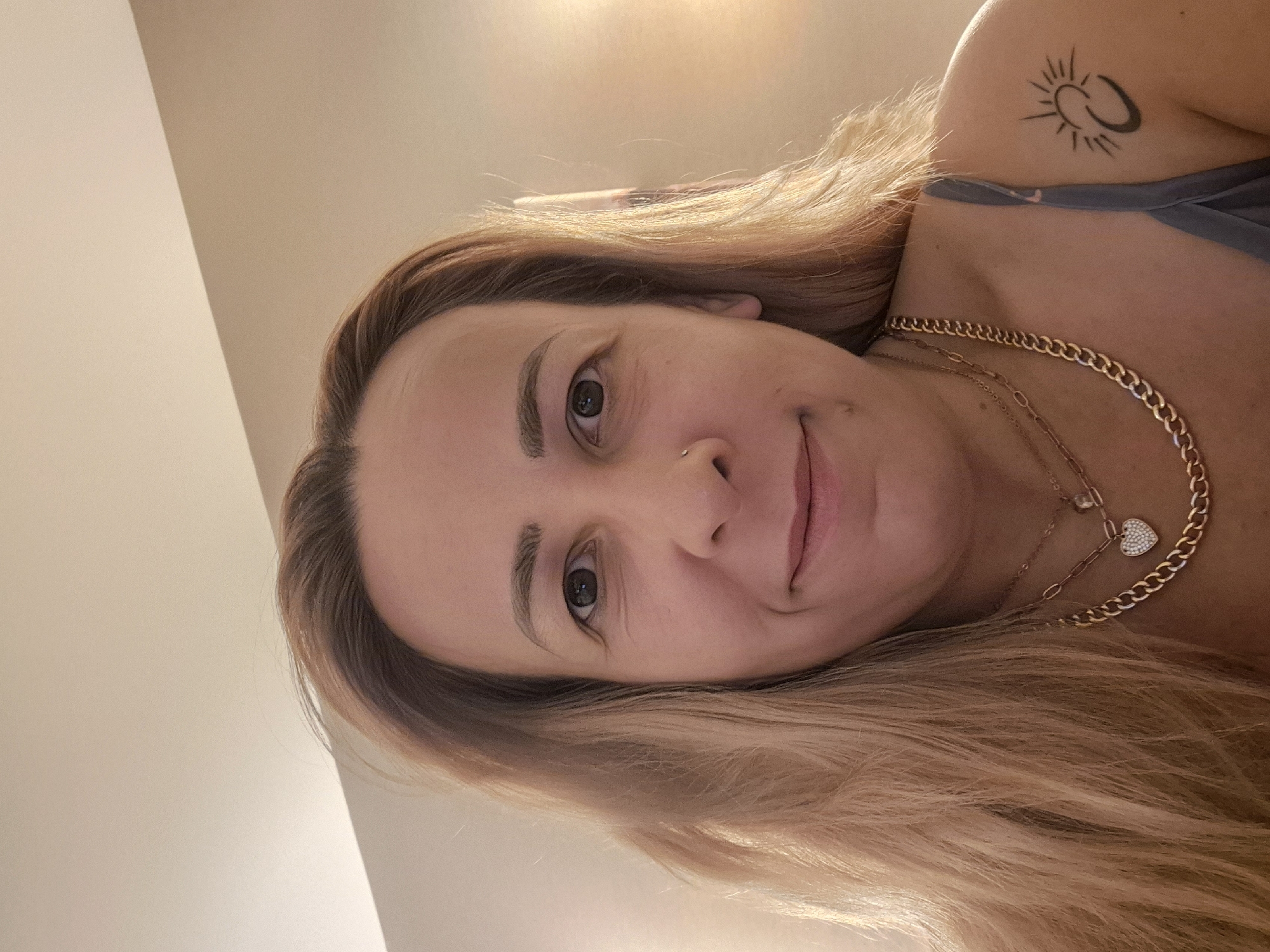 Bedroom selfie series with celestial top and gold jewelry