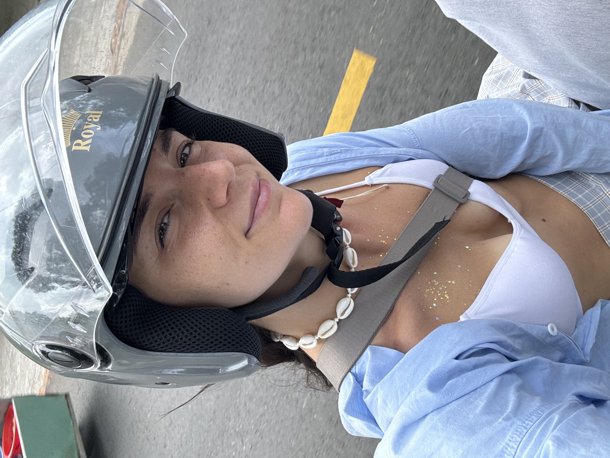 Woman rides motorcycle in bikini through Mũi Né streets