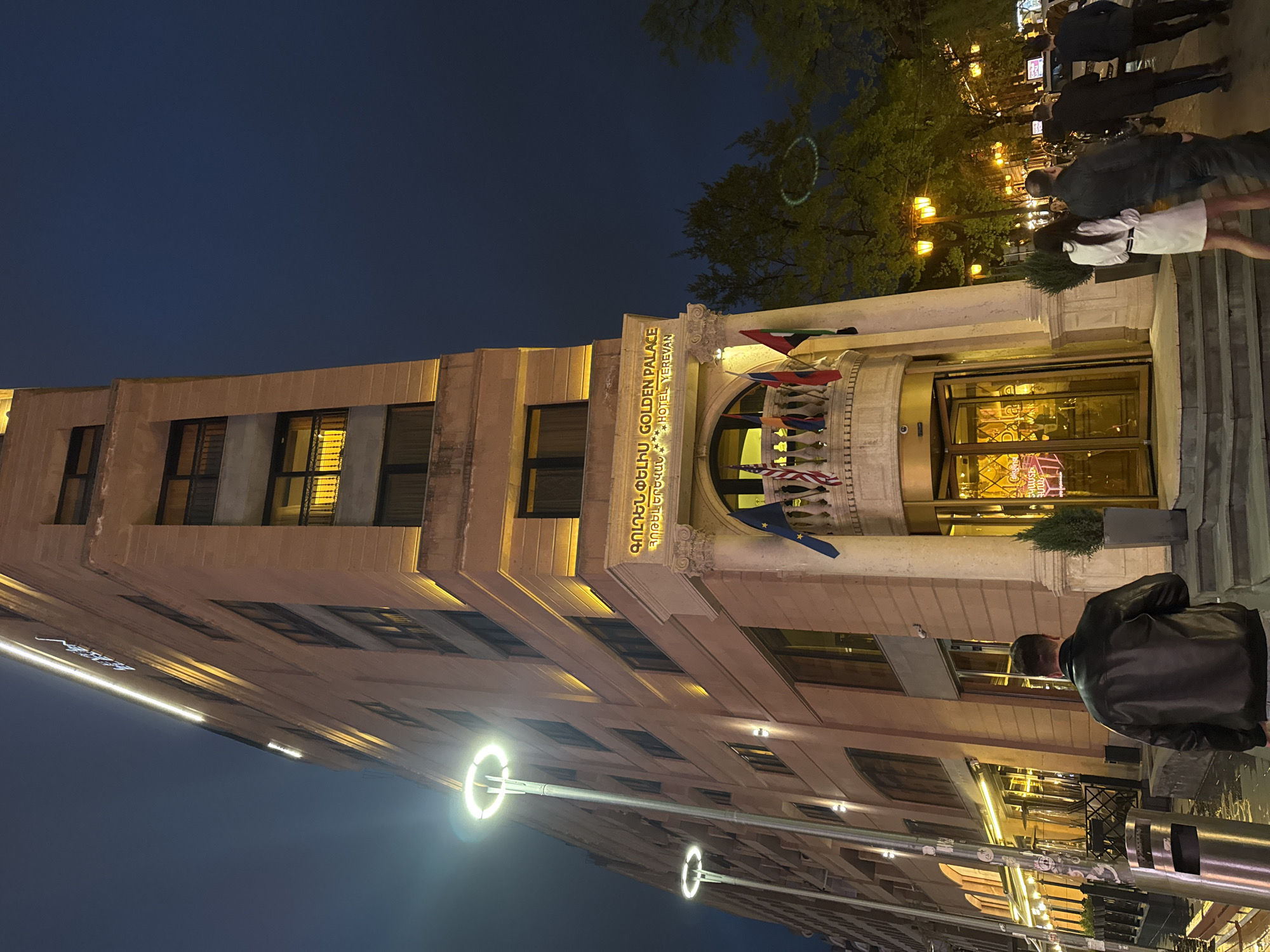 Illuminated hotel captures attention on wet Yerevan street