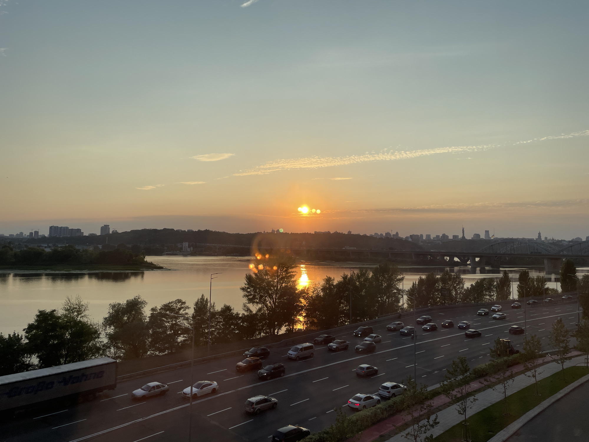Urban highway and waterfront from golden hour into night