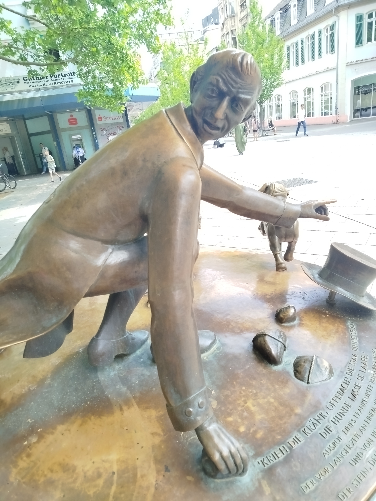 Street-level snapshots from Offenbach: sculpture, shop window, parked bike