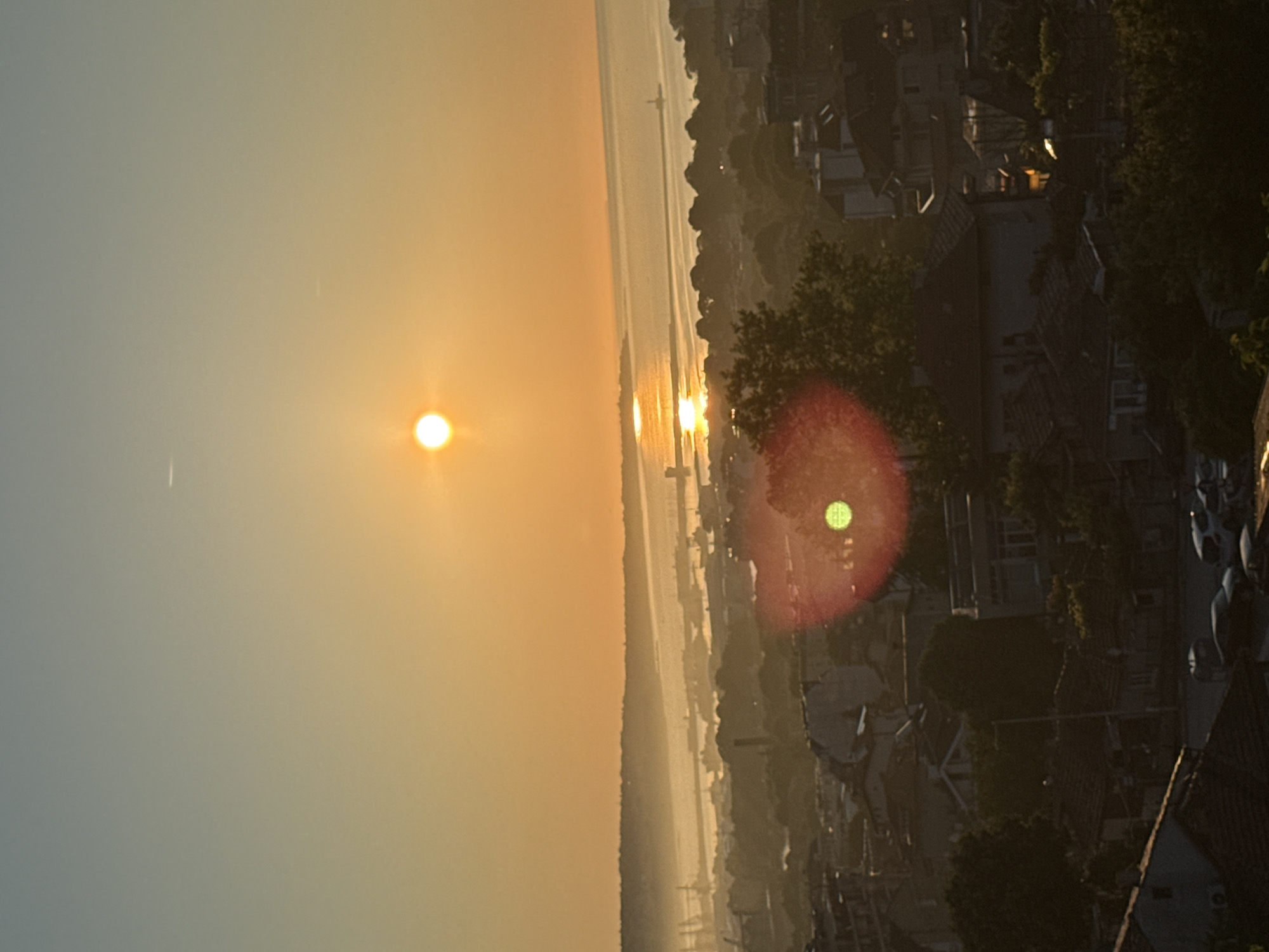 Urban dawn scenes documented across city during golden hour
