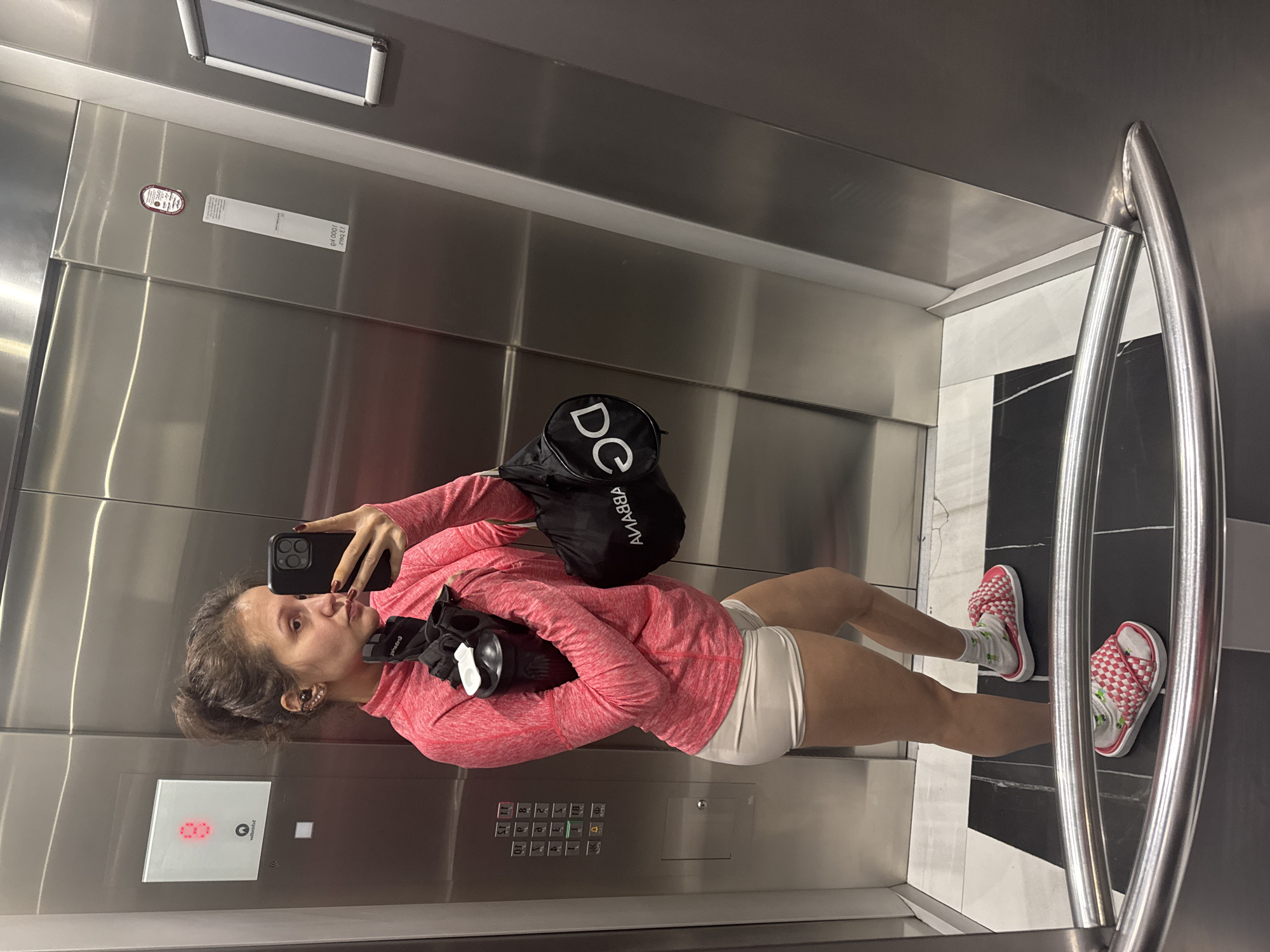 Woman takes elevator selfie in athletic wear in Dubai