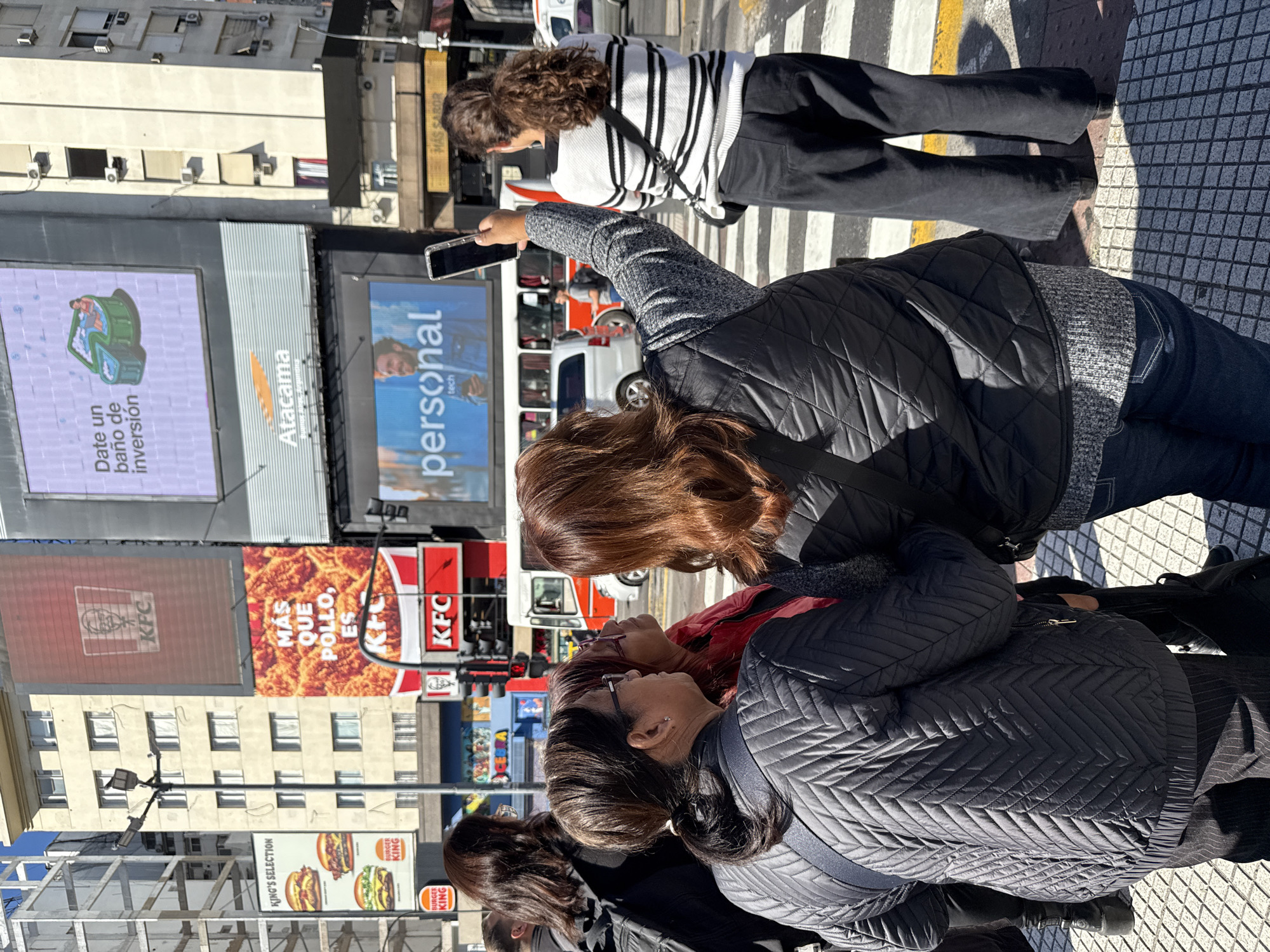 Daily life continues around Buenos Aires Obelisco on sunny afternoon