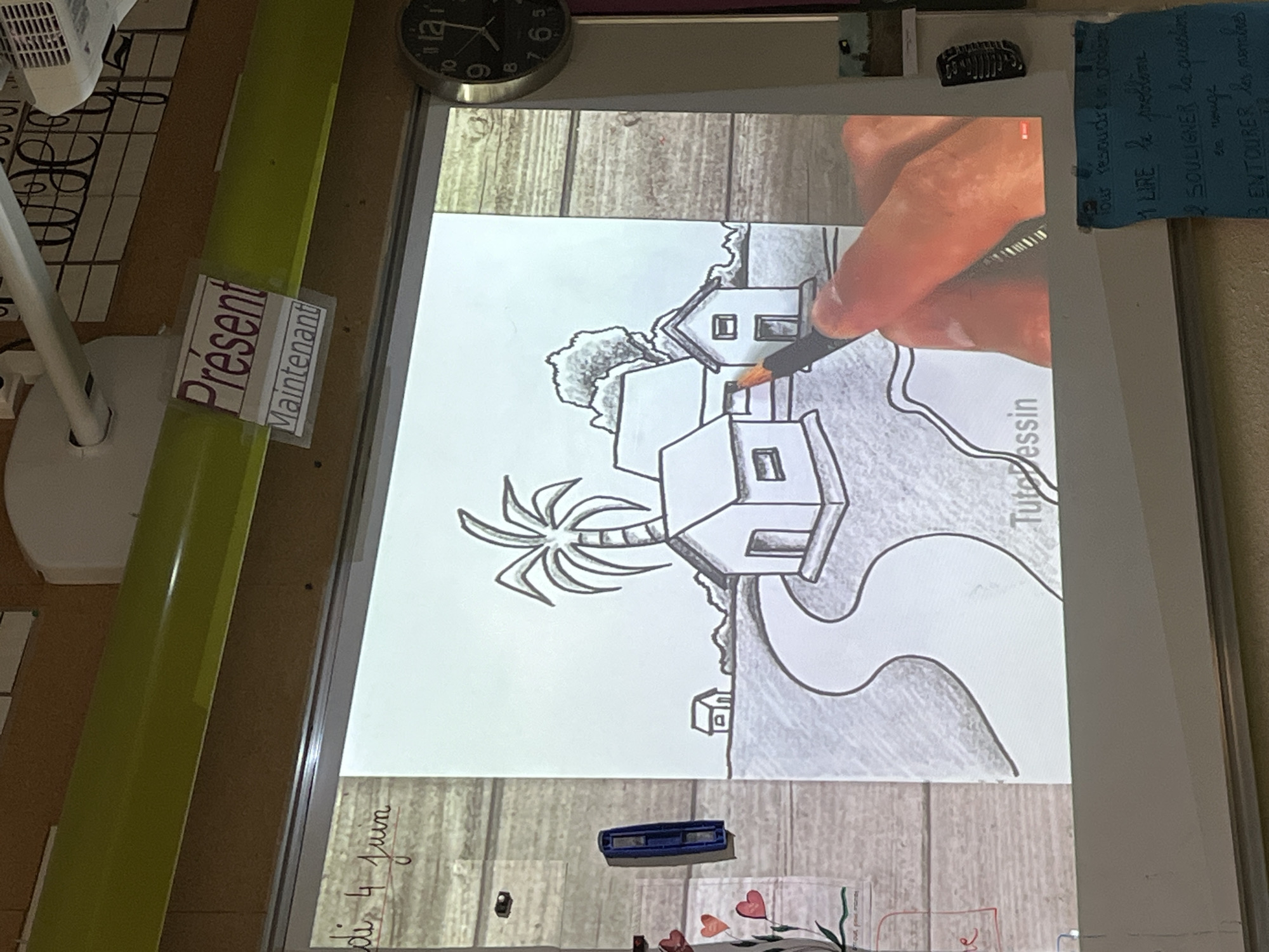 Art lesson captures village drawing tutorial in French classroom