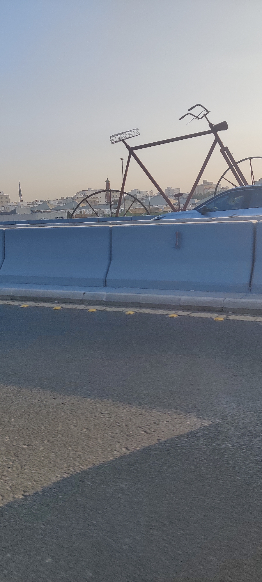 Decorative bicycle sculpture spotted on Jeddah highway barrier
