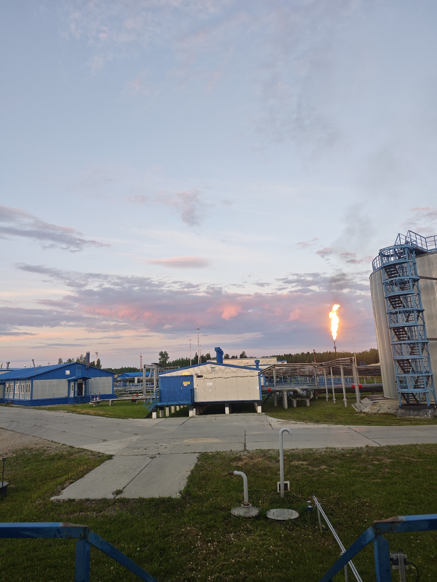 Industrial facility flare stack operations documented at sunset