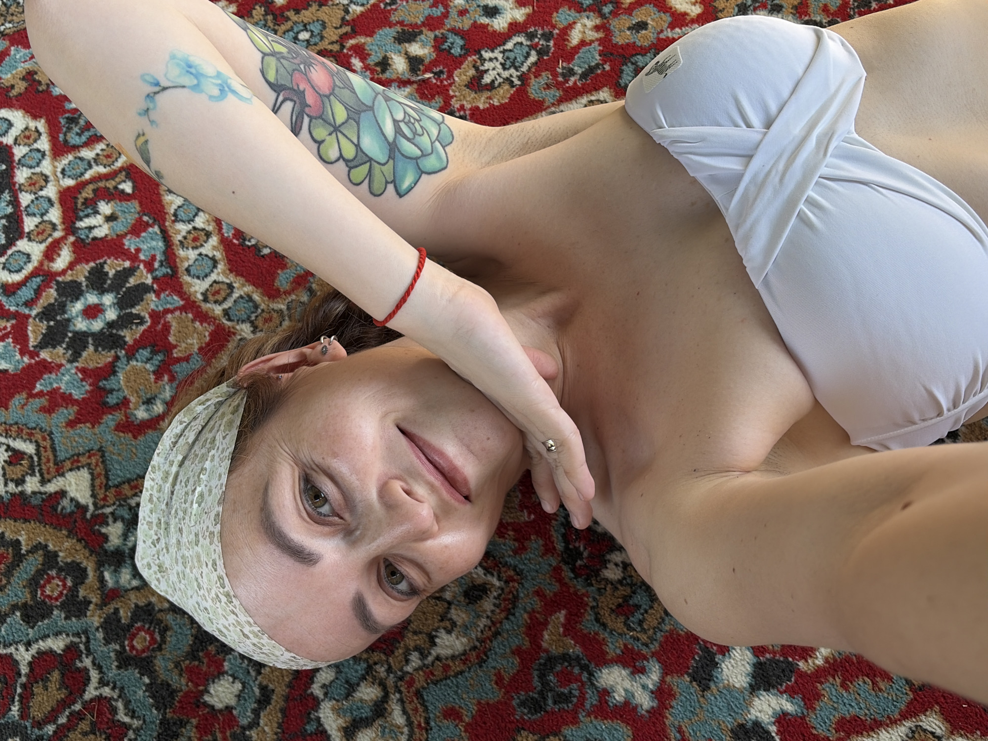 Woman photographed with ornate rug in Chaikovsky, Russia