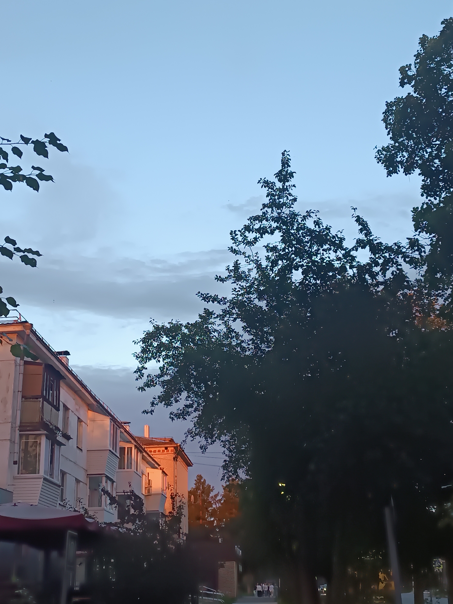 Summer evening around Chaikovsky's fountain square at sunset