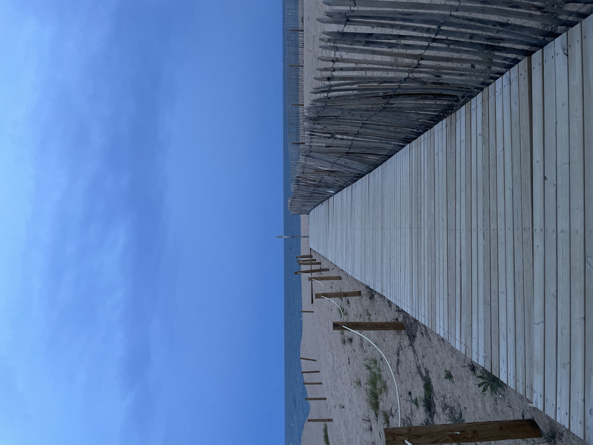 New wooden boardwalk observed extending to coastline in Calella