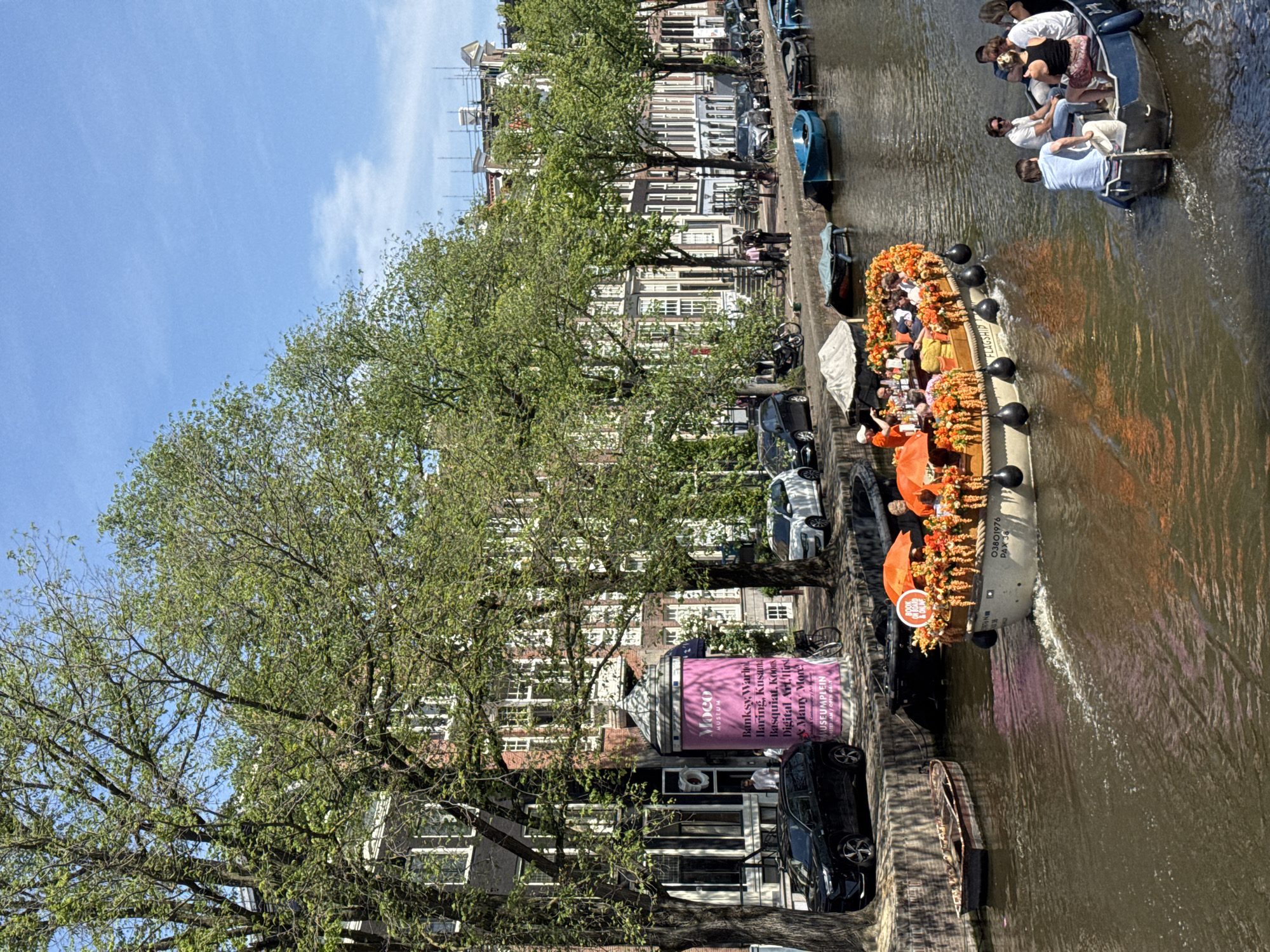 Amsterdam canal boats and Delftware shops observed midday