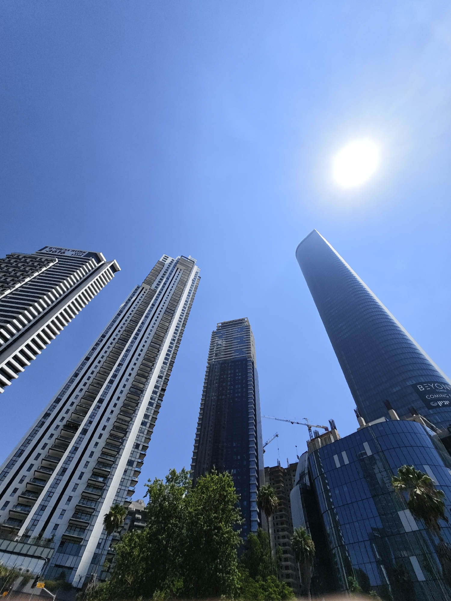Givatayim's glass towers reaching into a clear midday sky