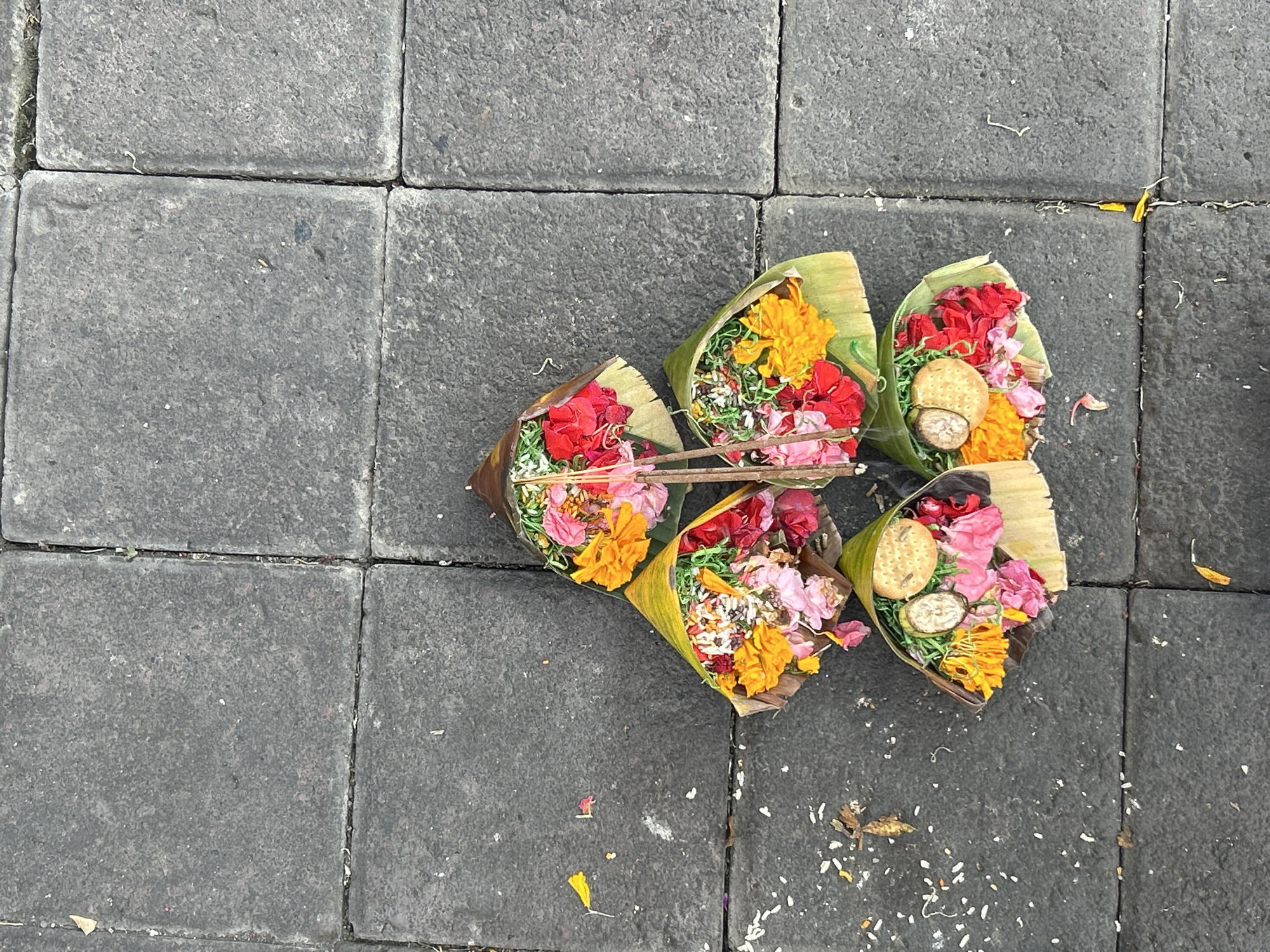 North Kuta street life: scooters, offerings, and sidewalk activity