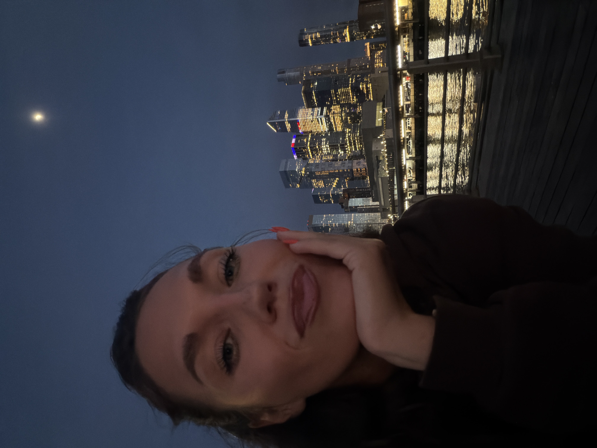 Woman selfie, city nightscape captured in NYC early morning