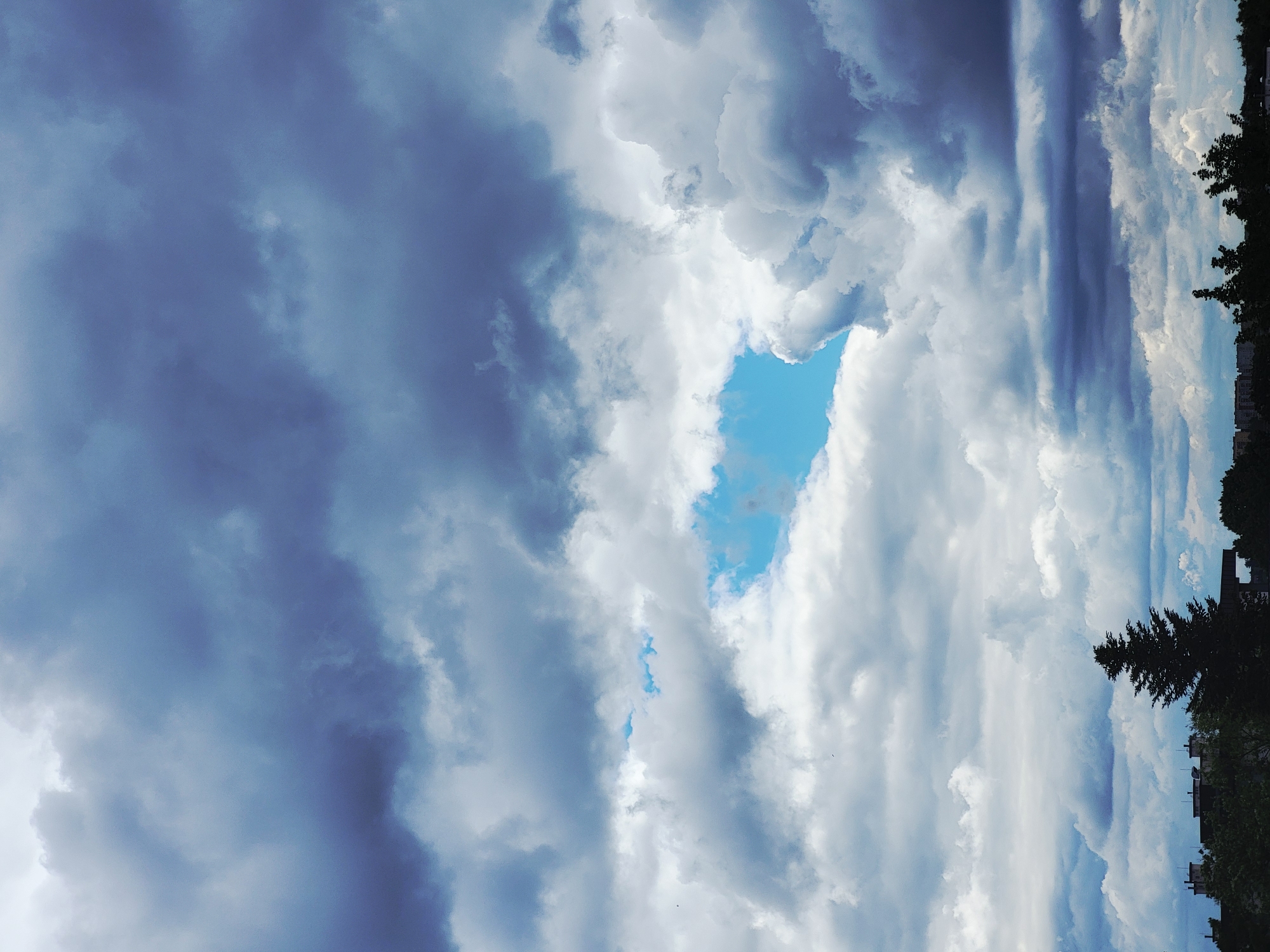 Dramatic cloudy sky over urban buildings during morning hours