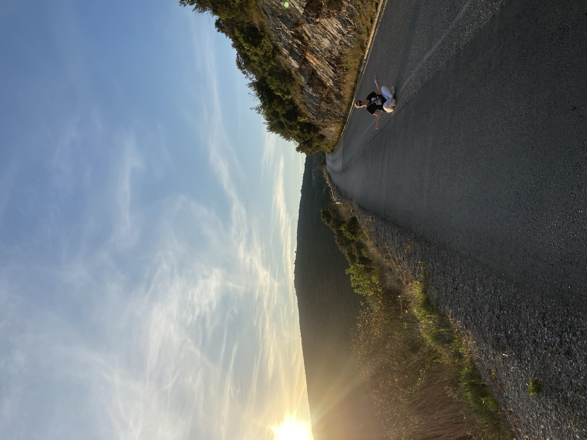 Person sits on mountain road in Višnjevo, Montenegro