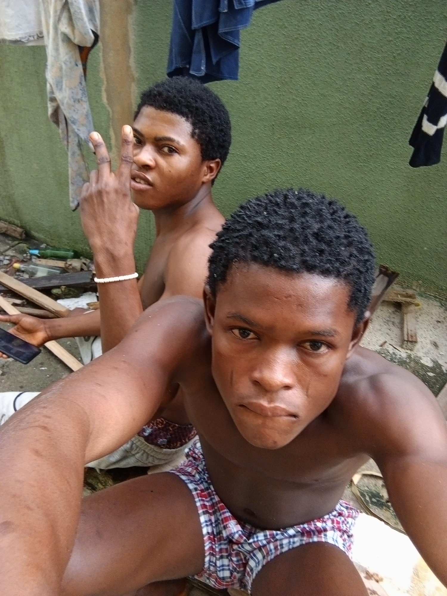 Casual morning outside a green apartment block in Ado, Nigeria