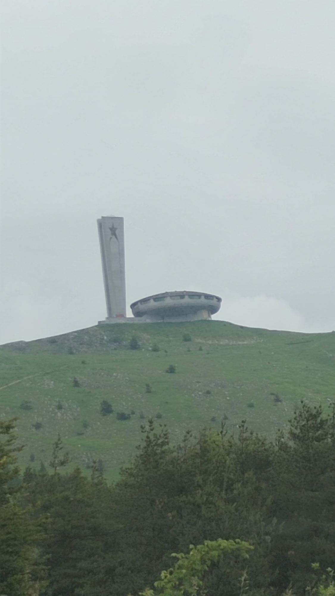 Travelers document Bulgaria's iconic Buzludzha Monument amid mountain landscapes