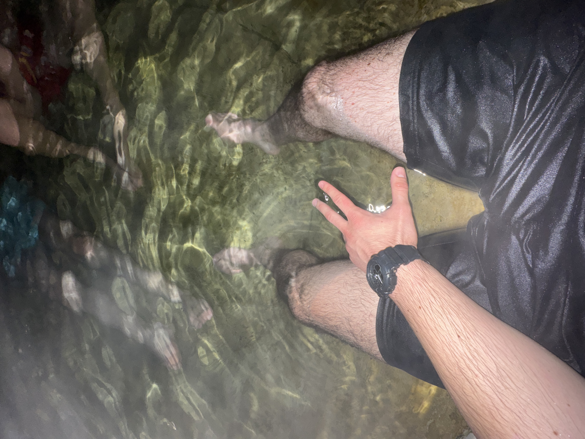 Person wades in clear water near Medousa, Greece