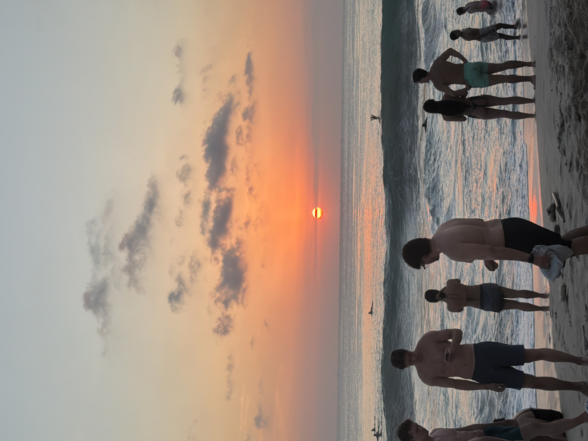 Sunset crowds gather on Kuta Selatan beach for surf and volleyball