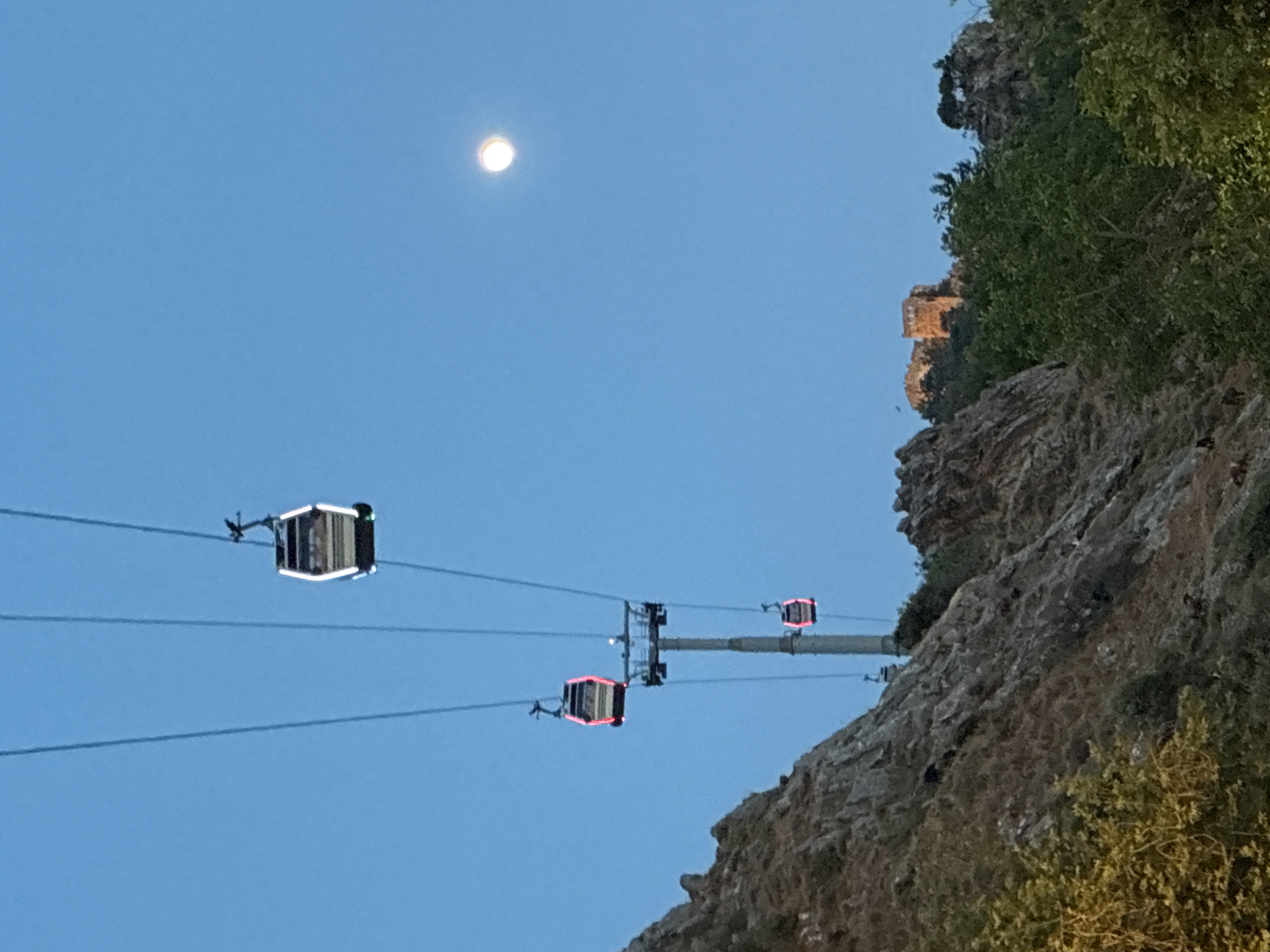Cable cars and fairy lights at dusk in Alanya