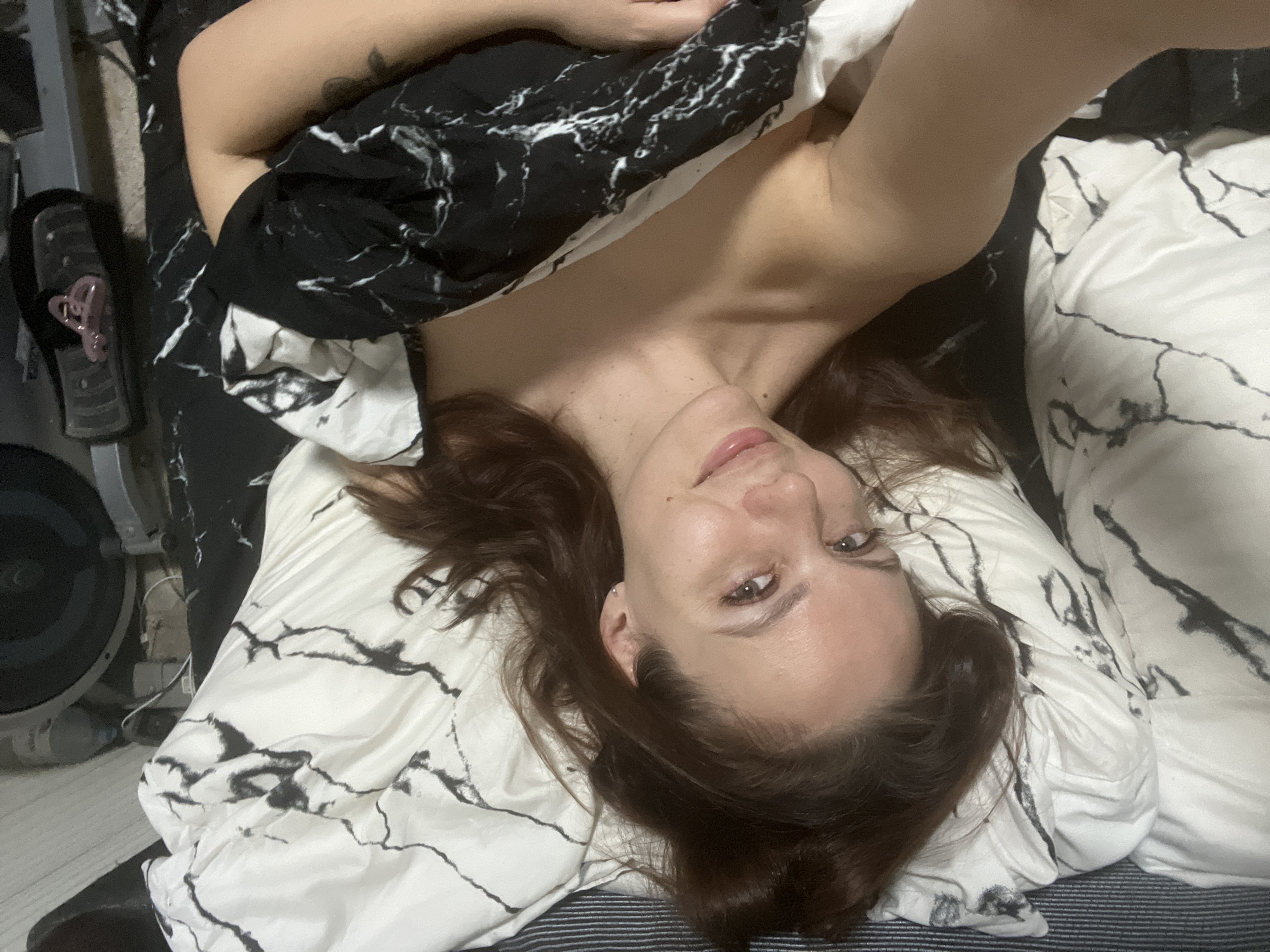 Woman takes multiple selfies in bedroom in Chaikovsky