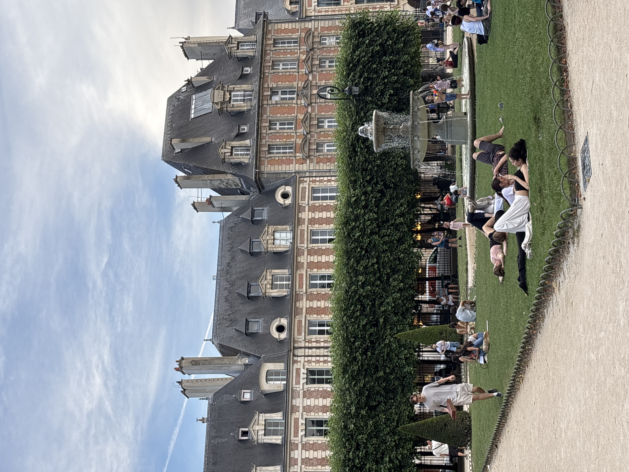 Locals and visitors unwind at Place des Vosges on a June afternoon